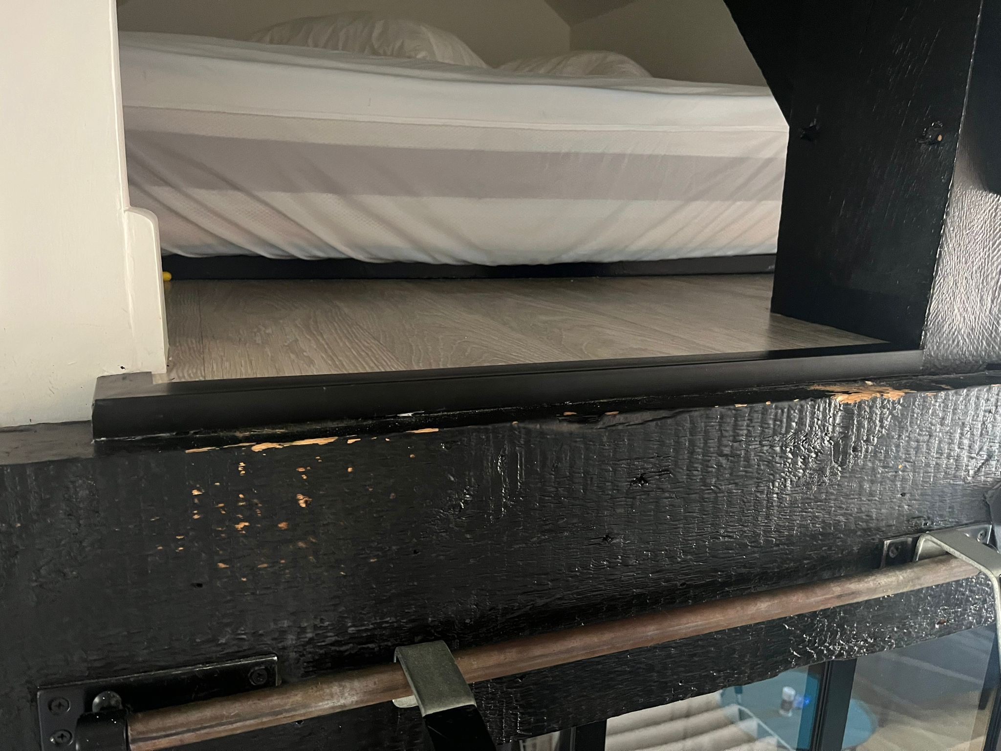 Boiserie noire écaillée avant retouches de peinture dans un appartement à Biarritz